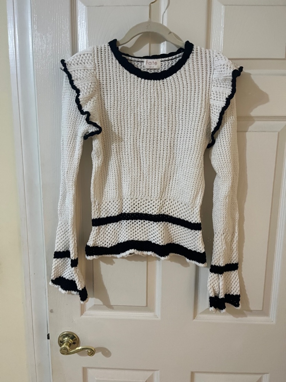White crochet sweater with black trim
Size M